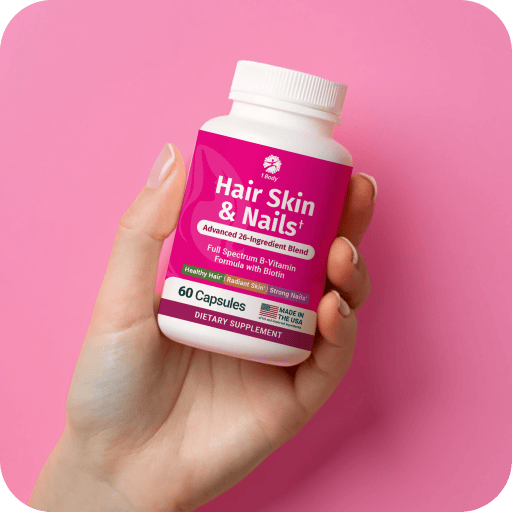 A hand holding a white bottle of Hair Skin & Nails dietary supplement against a vibrant pink background.