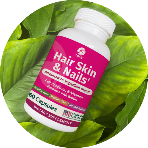 A white plastic bottle of 1 Body Hair Skin & Nails dietary supplement, featuring a bright pink label, set against a circular background of vibrant green leaves.